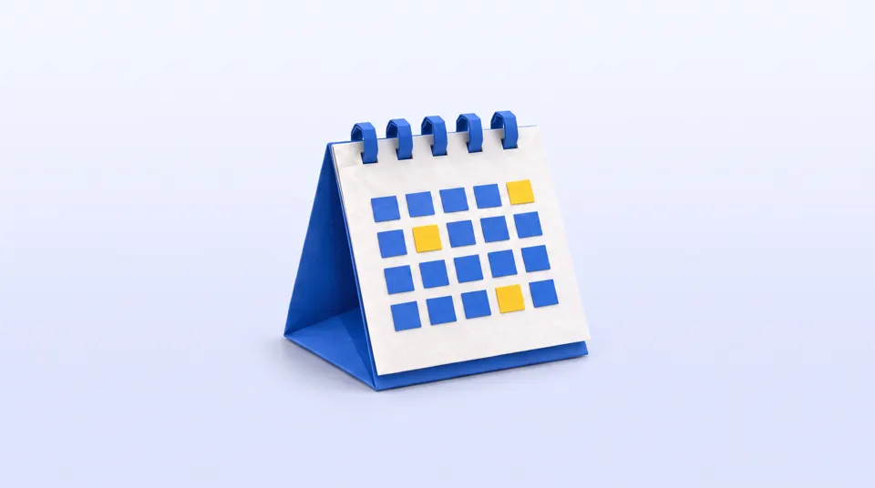 A folded paper desk calendar with blue and yellow squares