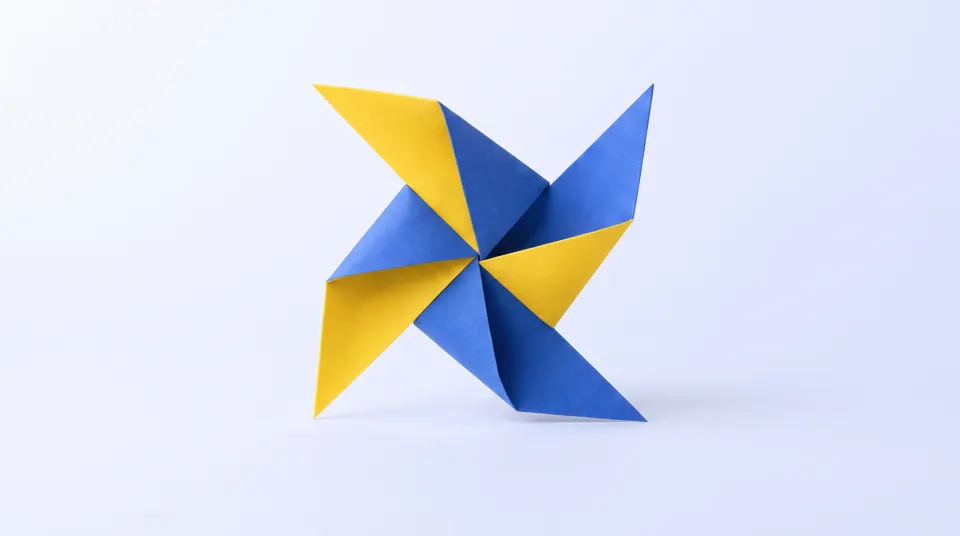 A blue and yellow origami pinwheel